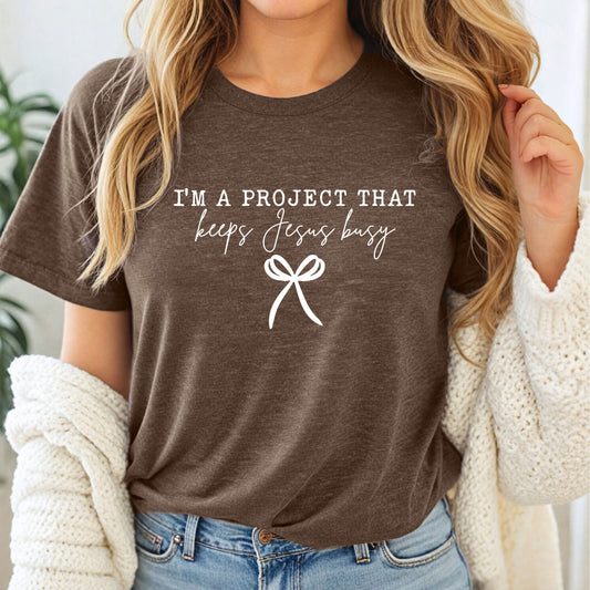 I’m a Project That Keeps Jesus Busy Graphic T-Shirt | Unisex Christian Tee
